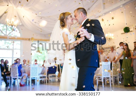 gorgeous stylish happy bride and groom performing their emotional first dance, wedding in a restaurant