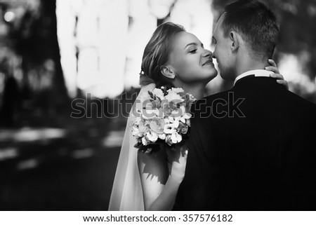Wedding day. Marriage. Wedding walk outdoors. Newlyweds with bouquet of flowers. Bride and groom portrait. Love, feelings, tenderness. Marriage bond