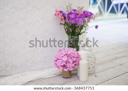 Stylish fresh pink an purple flowers at wedding reception closeup