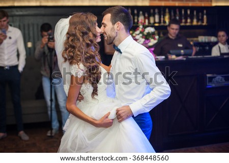 Beautiful newlywed couple first dance at wedding reception surrounded by smoke and blue lights