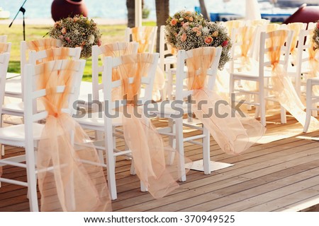 A lot of wedding chairs and luxurious tent near the pgreen lawn