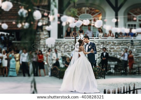 Sensual happy newlywed couple dancing outdoors at reception