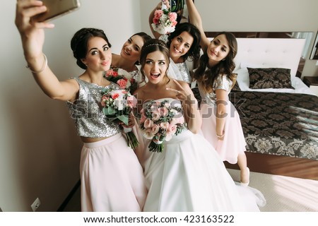 Bride and bridesmaids are taking a selfie