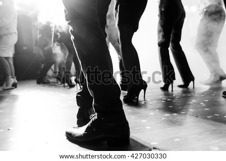 Legs of dancing people at the party