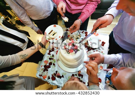 Guests share a wedding cake