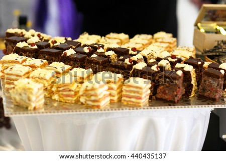 Yellow and brown cakes lie on a big tray