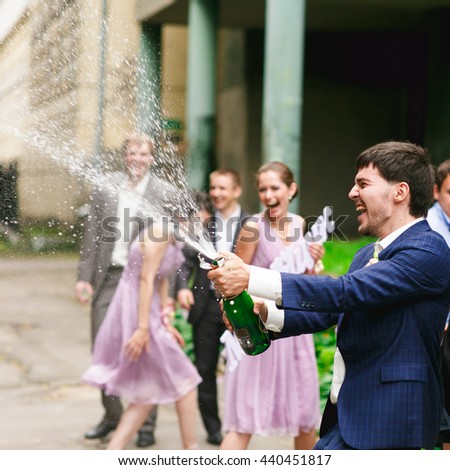 Groom breaks out the champagne on the street