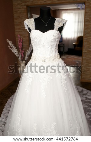 The wedding dress stands near room