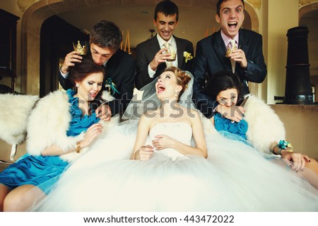 Groom and groomsmen attack girls sitting on the couch