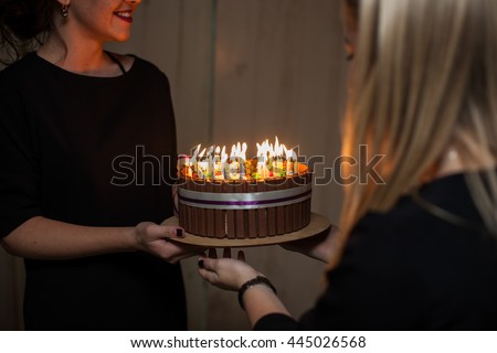 The friend presents a cake on the birthday party
