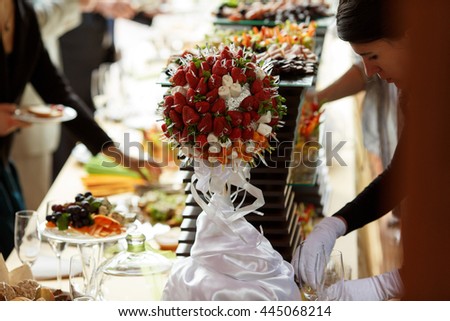 Waiter get ready a buffet full of fruits