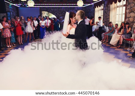 Awesome wedding couple dances in the hall full of smoke
