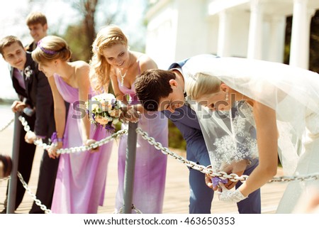 Couple and the bridesmaids in the park in the wedding day