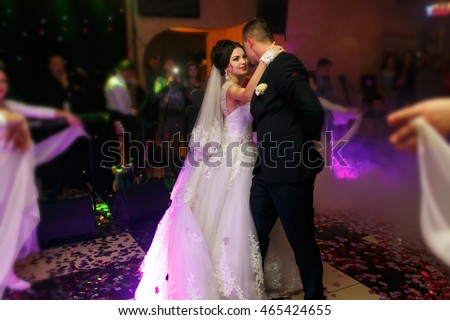 The lovely couple in love dancing on the dancefloor