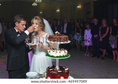 happy just married couple cut their beautiful delicious tasty unusual cake