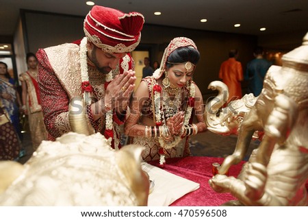 Beautiful wedding couple prays to Indian god