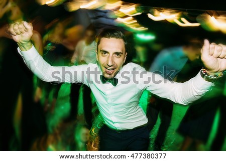 Groom dances on the wedding in the evening