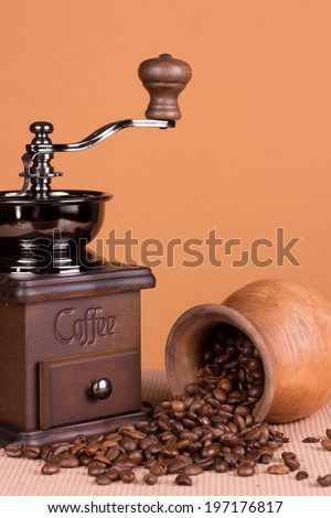 Vintage coffee grinder and a pitcher with roasted beans