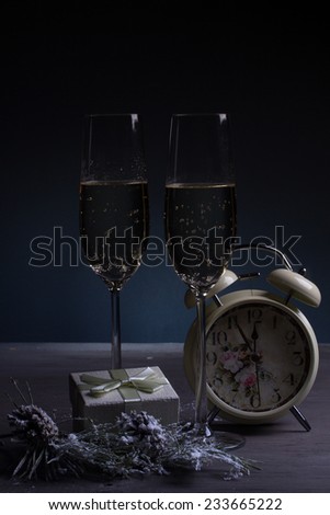 Christmas background with vintage alarm clock and glasses with champagne