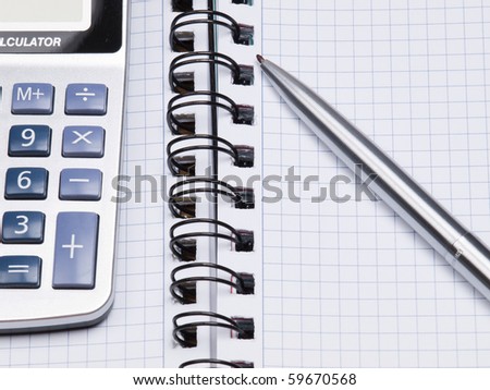 Opened business diary, pen and calculator