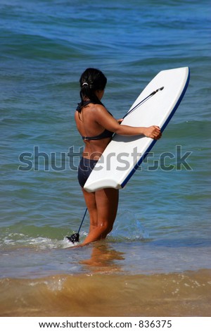 Girl cooling off at the beach with boogie board