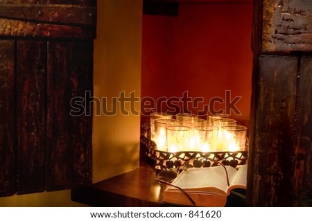 Candle lit Bible with reading glasses
