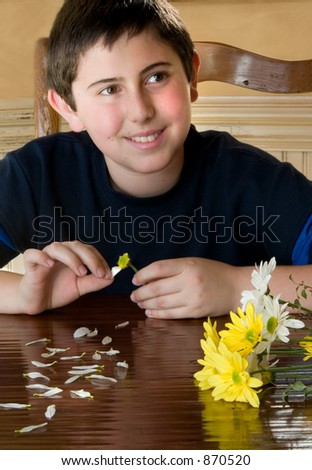 Young man with daisies Playing she loves me, She loves me not