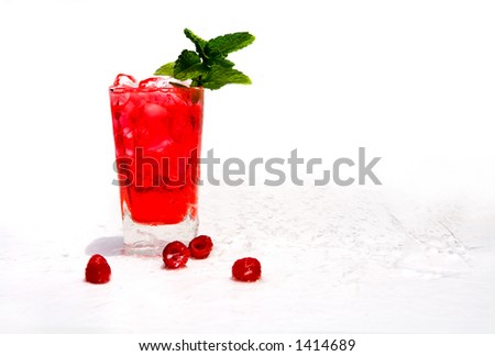Raspberry cocktail on ice with berries caught in water splash