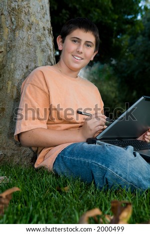 Young man outside trying to do his homework until dad decided to take photos