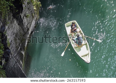 Takachiho, Japan - September 28, 2014: a japanese couple in a rental boat at the Takachiho Gorge. Takachiho City. Nishiusuki District. Miyazaki Prefecture. Japan.