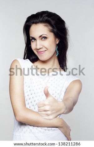 Young pretty woman showing hand ok sign