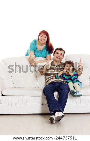 Father, mother and son sitting on the sofa showing hand ok sign over white background