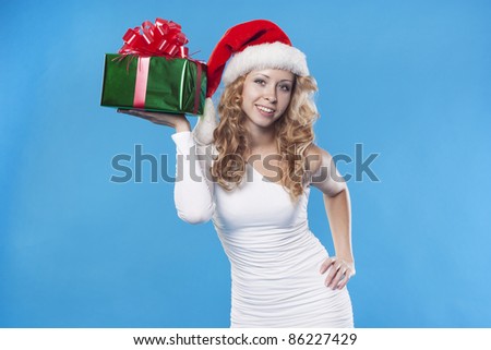 Pretty Santa girl with a present gift for New Year