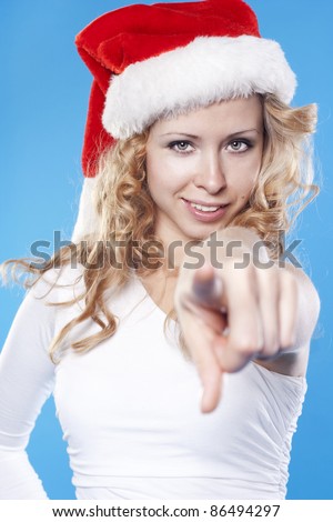 Young Santa woman pointing at you