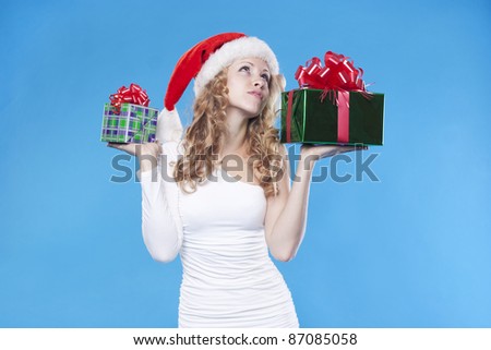 Pretty Santa girl with a present gift for New Year or Christmas