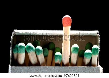 Match boxes and green matches (one match red). A black background.