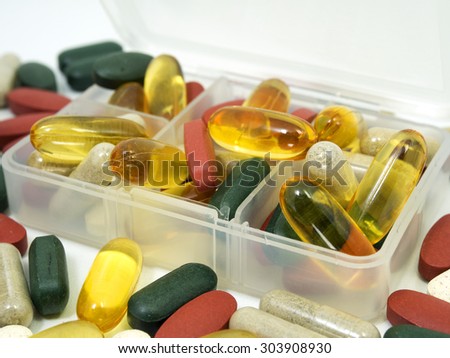 group of Vitamin with pill box,pill box,Vitamin,drug,multivitamin, herbal supplement capsules,fish oil,Natural organic green algae tablets,Colorful,pills and tablets, background