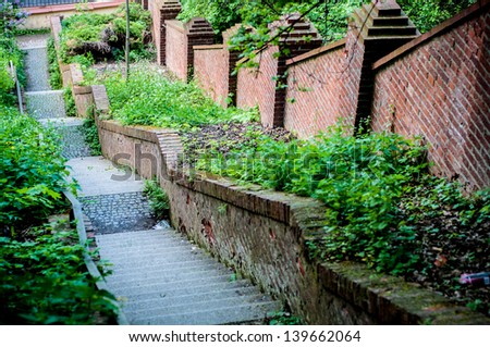 long outdoor stairs and brick wall