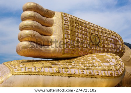 A foot print big statue of reclining buddha image in the temple, Phrae province Thailand