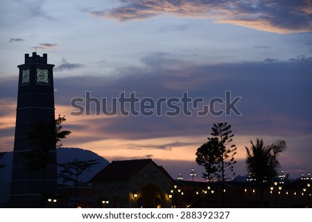 Clock tower and abstract night light bokeh after sunset on twilight time