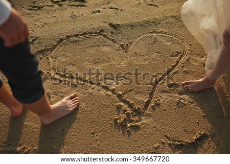 Just married couple running on a sandy beach