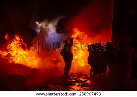 Protesters on fire with camera and shields
