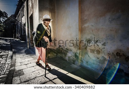 An old woman walking down the street the morning of Lviv, Ukraine, 06/21/2014