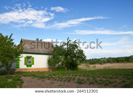 Traditional cottage house with a garden in central region of Ukraine