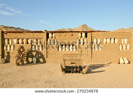 Wall of the old clay house decorated with pots in Africa