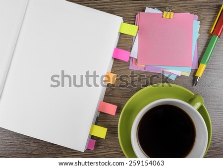Colored stickers notebook and coffee on old wooden table