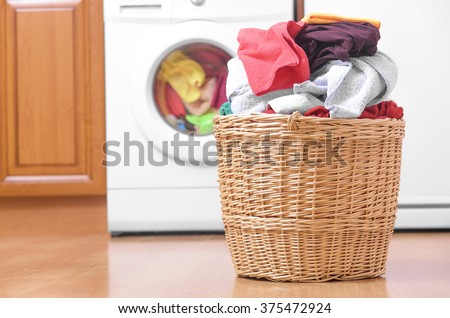 Laundry basket on the background of the washing machine.
