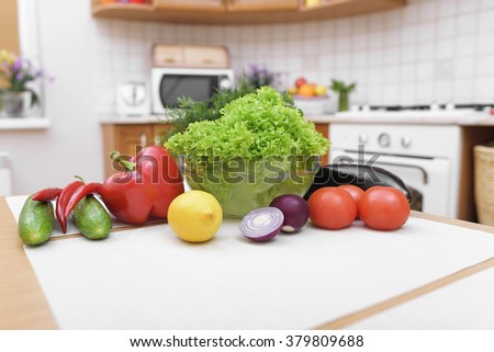 Fresh vegetables for salad on a kitchen table.
