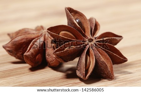 Star Anise spice macro, delicious licoricey flavor on wooden background in full frame.