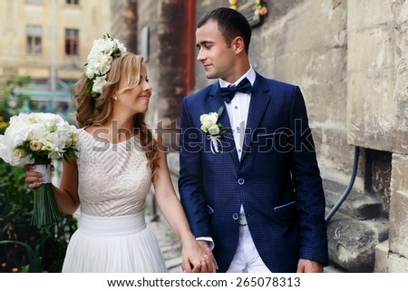happy just married young couple celebrating and have fun at beautiful cathedral